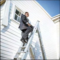 A suited man climbing a ladder against a white house generated by Janus-Pro